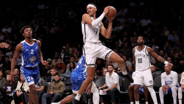 Oct 12, 2023; Brooklyn, NY, USA; Brooklyn Nets forward Darius Bazley (7) looks to pass the ball against Maccabi Ra'anana guard Ashton Hagans (2) and forward Julien Ducree (54) during the third quarter at Barclays Center